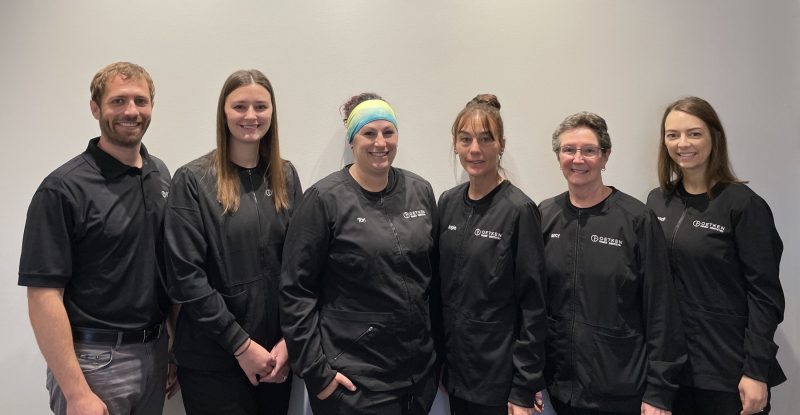 Group image of the staff smiling in the office
